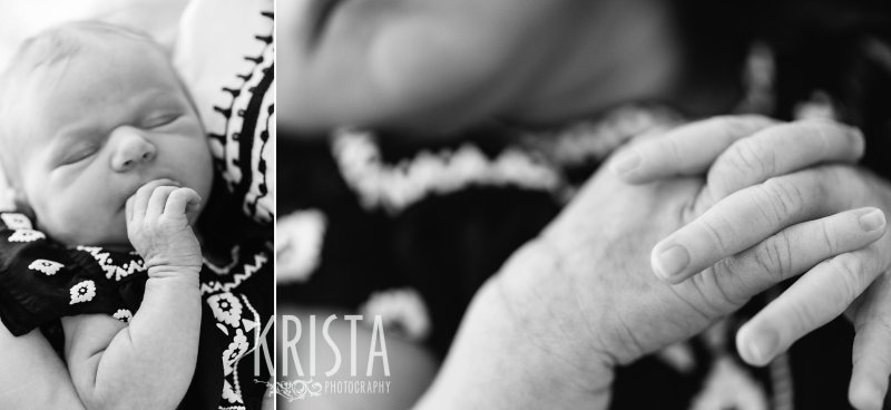 black and white image of newborn baby girl with fingers entwined during lifestyle family portrait session at home