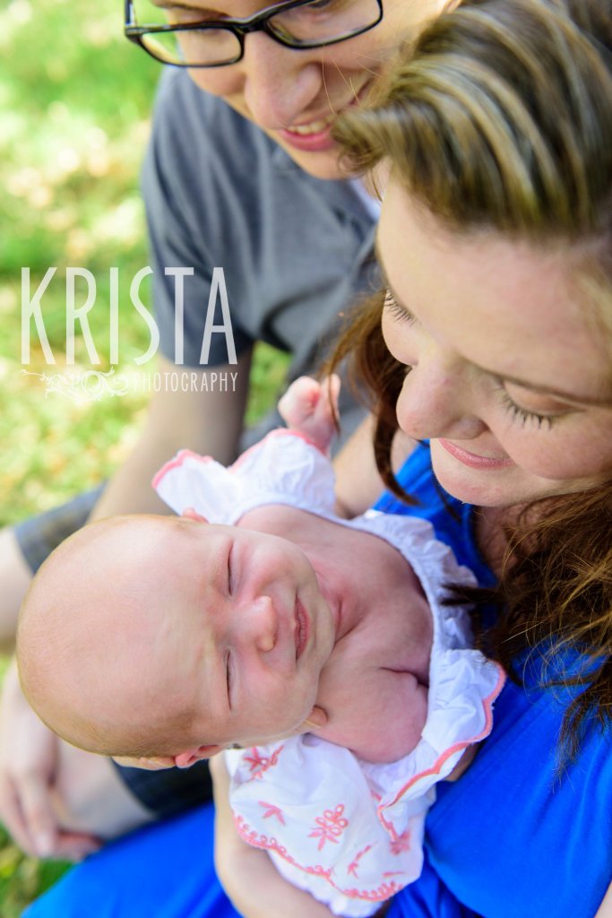 brand new infant baby girl being held by mother during springtime mini portrait sessions in New England