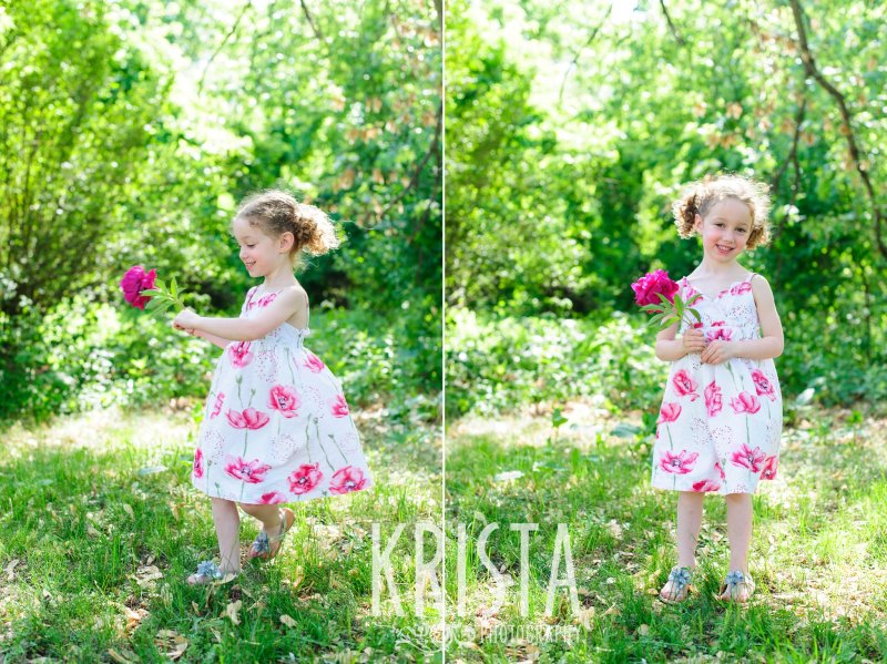 sweet little girl with curly pigtails twirling in grass with pink flowers during spring mini portrait session