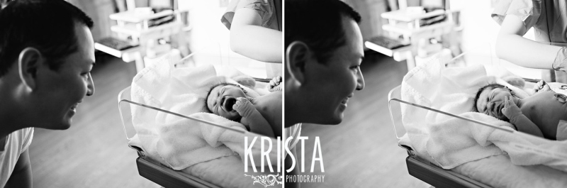 black and white image of father seeing newborn baby son for first time in hospital during lifestyle birthing portrait session