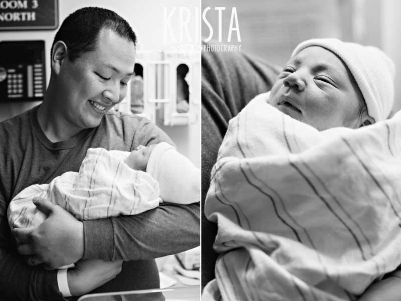 black and white image of new father proudly holding newborn baby boy in hospital soon after his birth