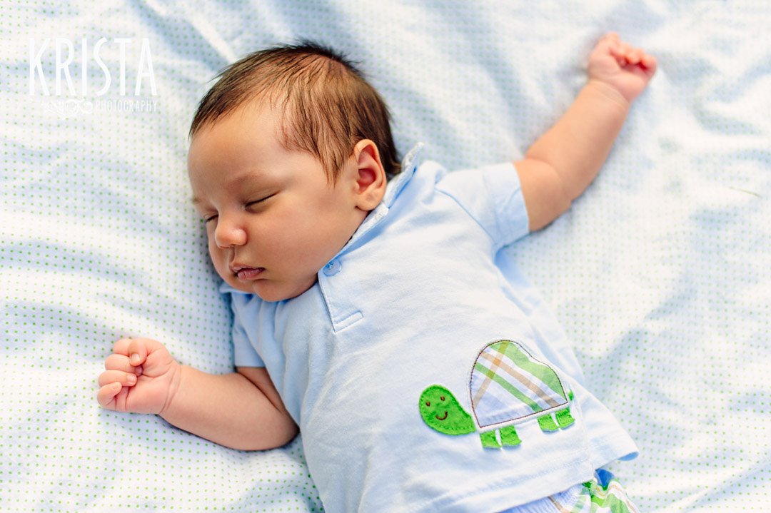 newborn baby boy at one month old during lifestyle portrait session with family outside