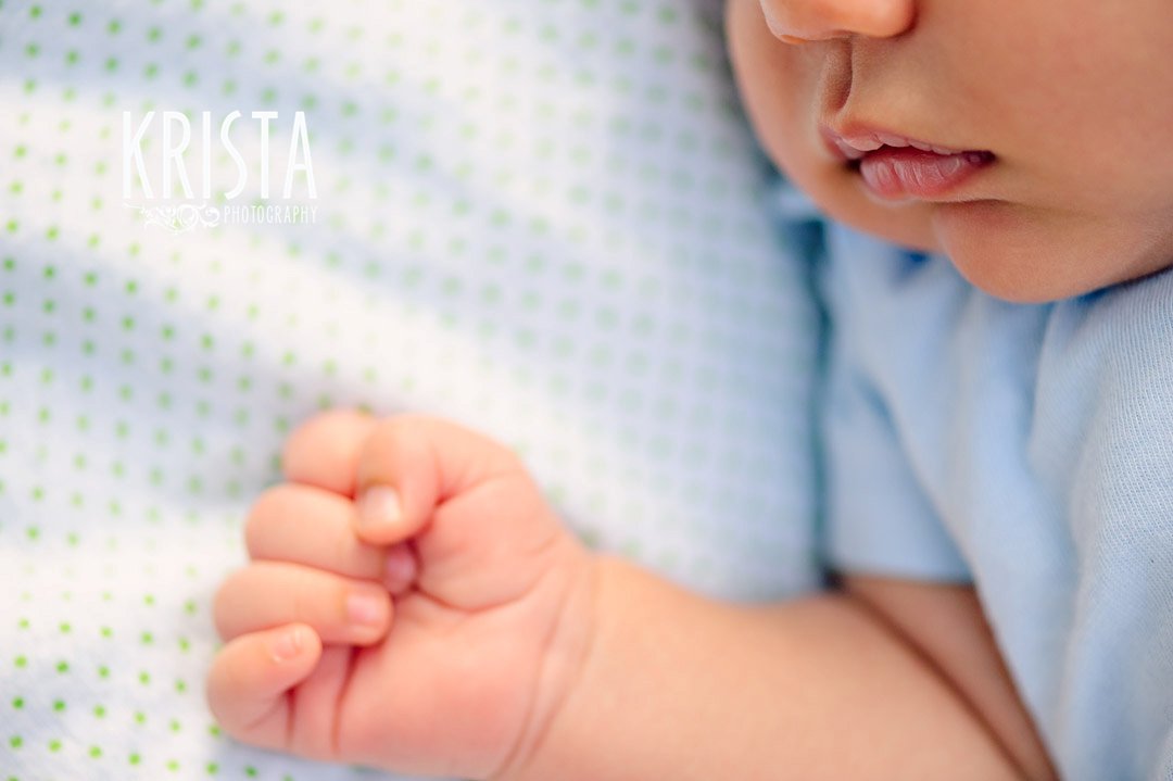 newborn baby boy at one month old during lifestyle portrait session with family outside