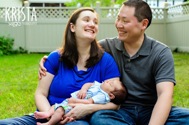 brand new family with newborn one month old baby boy outside during lifestyle portrait session