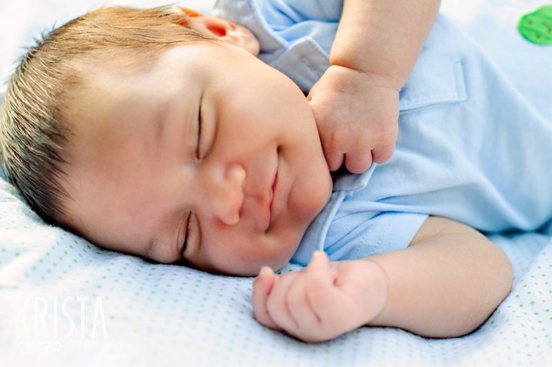 newborn baby boy at one month old during lifestyle portrait session with family outside