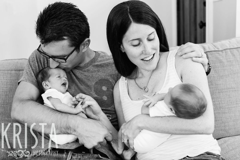 black and white image of family with newborn baby boy girl twins at home