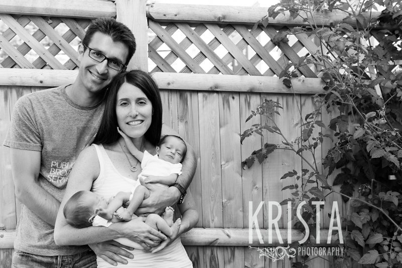 black and white of family with newborn baby twins in backyard