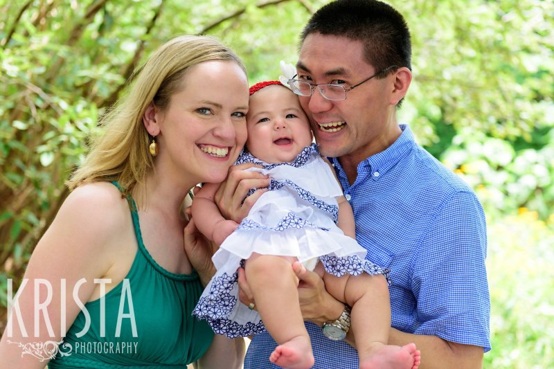 bi-racial family in backyard of home during lifestyle portrait session