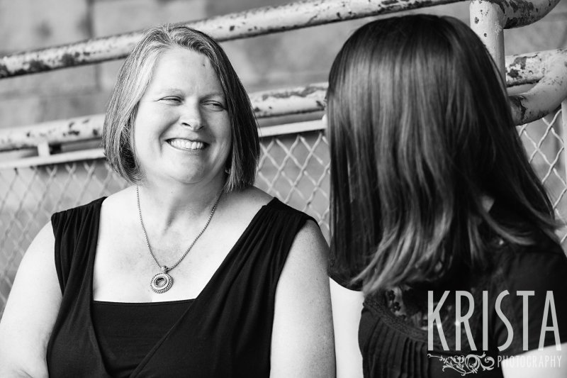 black and white image of mother and daughter talking during lifestyle family portrait session
