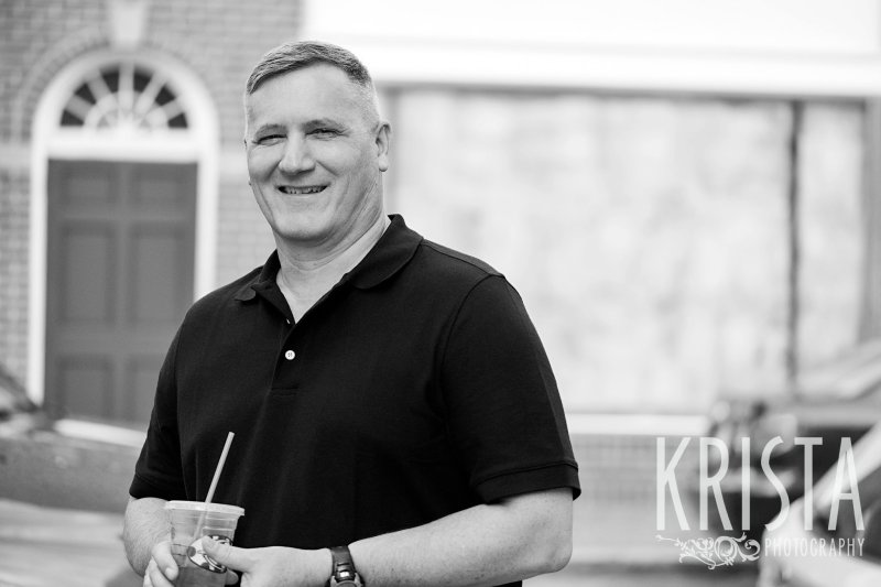 black and white image of father during lifestyle portrait session near family home in winchester, ma
