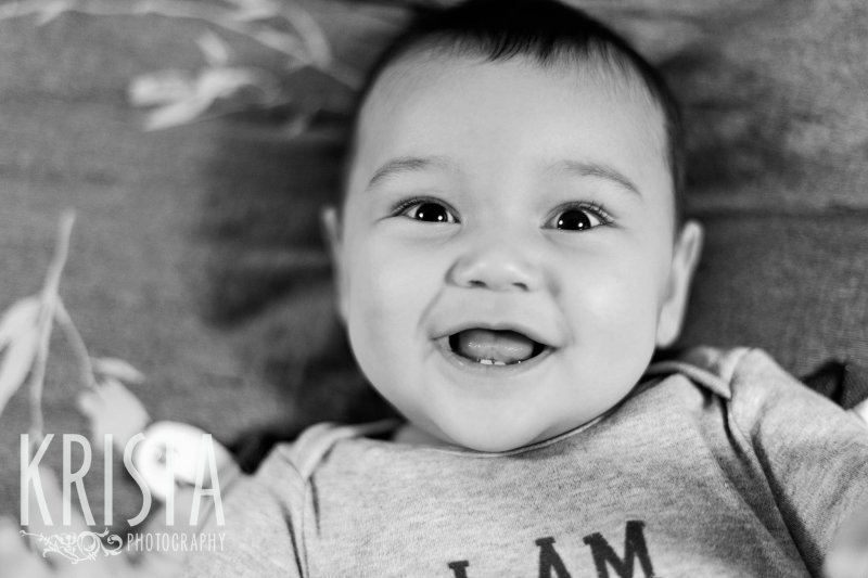 black and white image of Asian baby boy during six month lifestyle portrait session at home