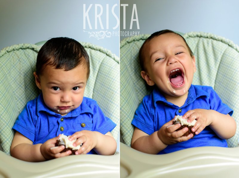 one year old baby boy in blue collared shirt trying cake on first birthday during lifestyle portrait session at home