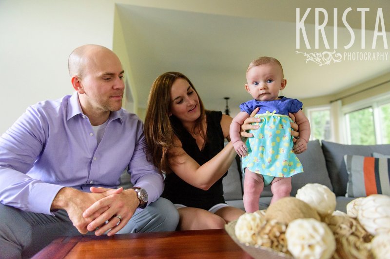 family with three month old baby girl in blue aqua and yellow dress in home during lifestyle portrait session