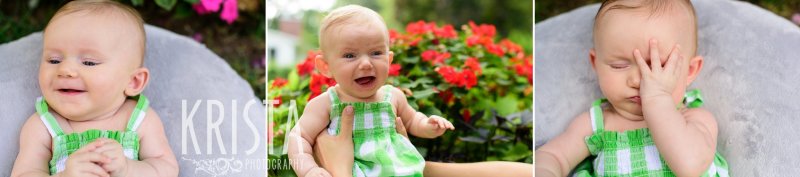 smiley and sleepy three month old baby girl in green gingham sundress in front of red flowers during lifestyle portrait session at home