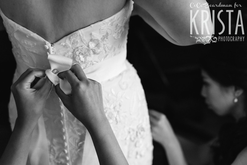 bride putting on her wedding dress © Krista Photography