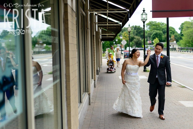 newlyweds walking through downtown © Krista Photography