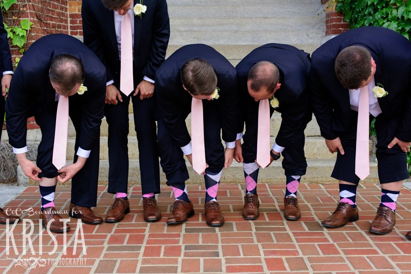 The groom and his groomsmen flashing their colorful socks. © 2016 Krista Photography - www.kristaphoto.com