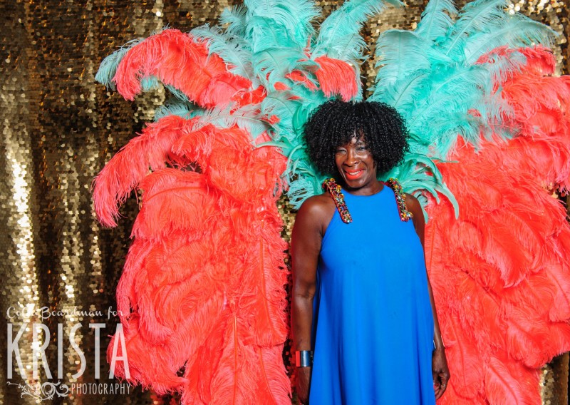 Bright feathered props and smiling guests
